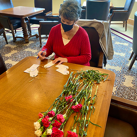 Resident helping write valentines wishes on cards