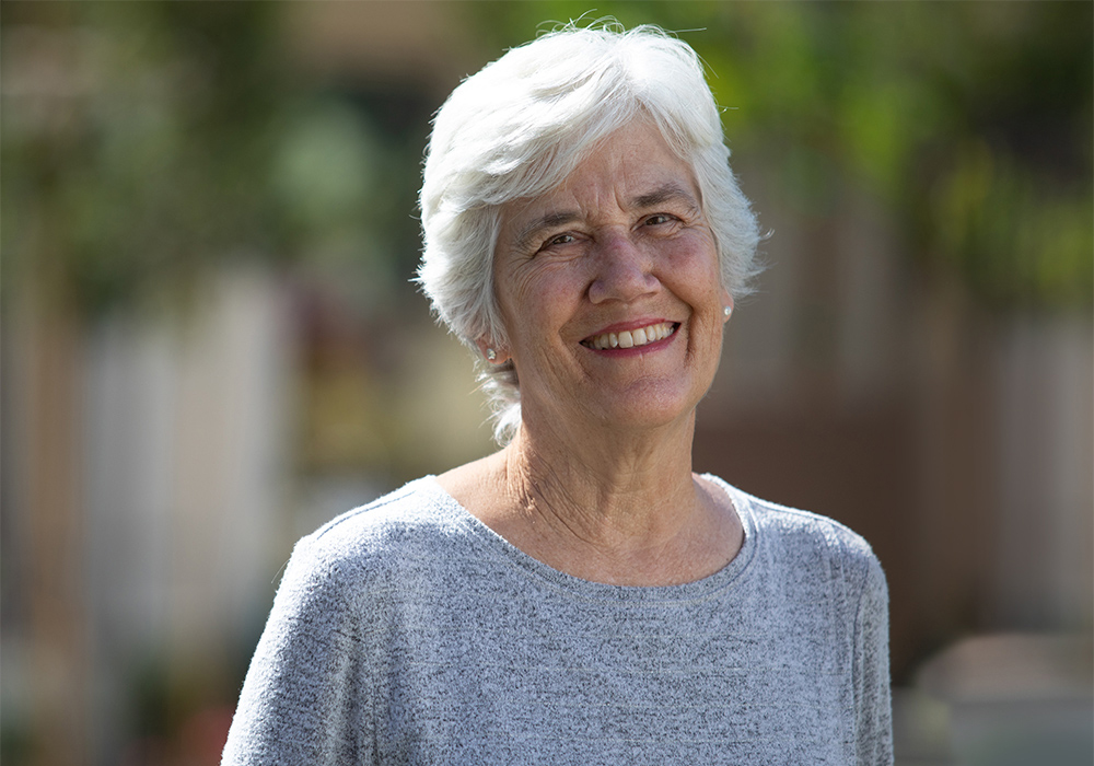 a mature woman smiling outdoors