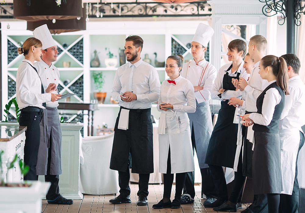 several chefs and servers prepping for the restaurant guests