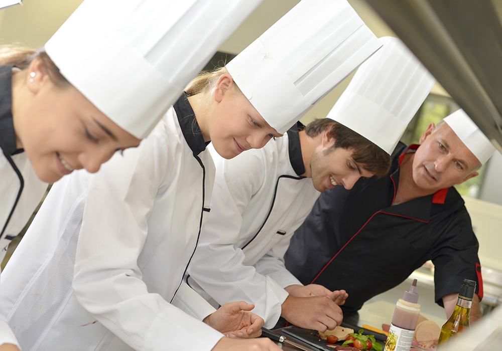 several chefs in the kitchen
