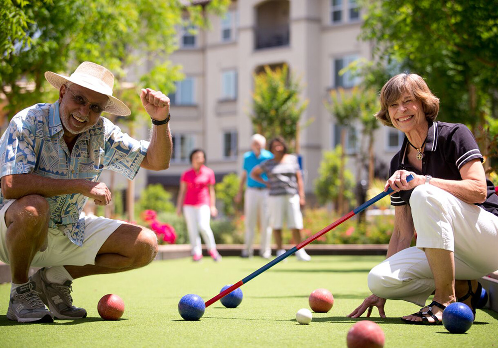 a mature couple playing bocce ball