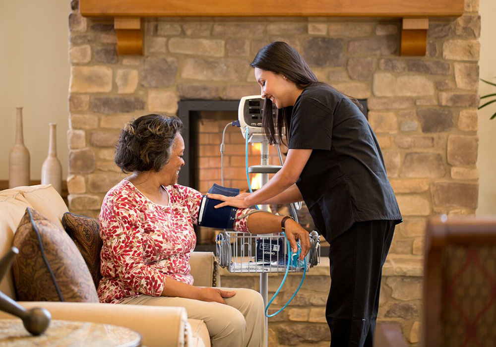 Woman getting her blood pressure taken in the lobby of the health center
