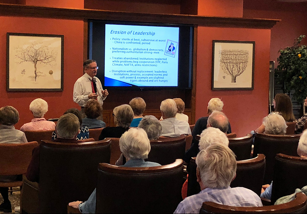 Man speaking on front of several seated senior adults