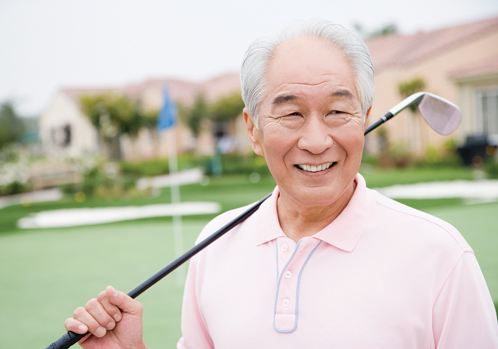 Man outdoors with a golf club over his shoulder