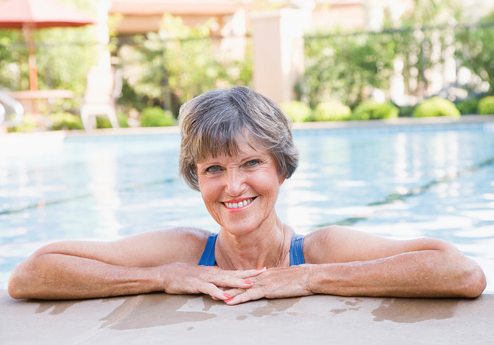 Happy woman outdoors in the swimming pool