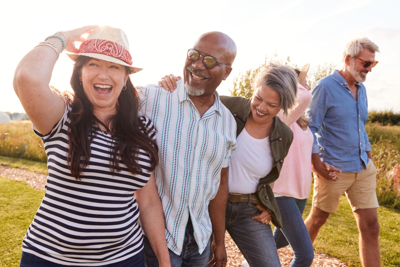 5 mature couple walking and smiling outside