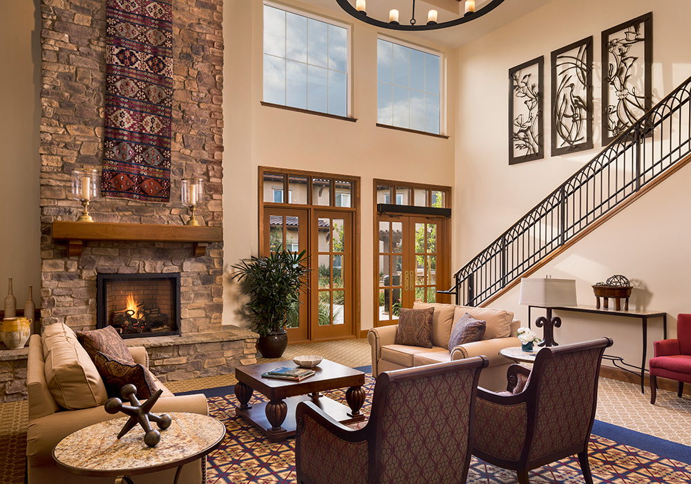 Lobby common area with grand staircase and fireplace.