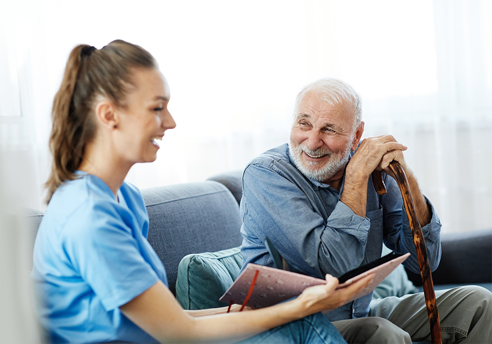 yolo-1000x700-29 Elderly man leaning against a cane with a caregiver