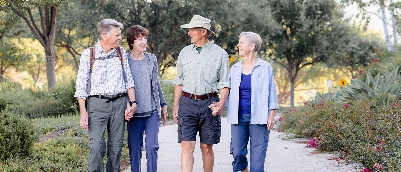 two couples out for a walk while holding hands