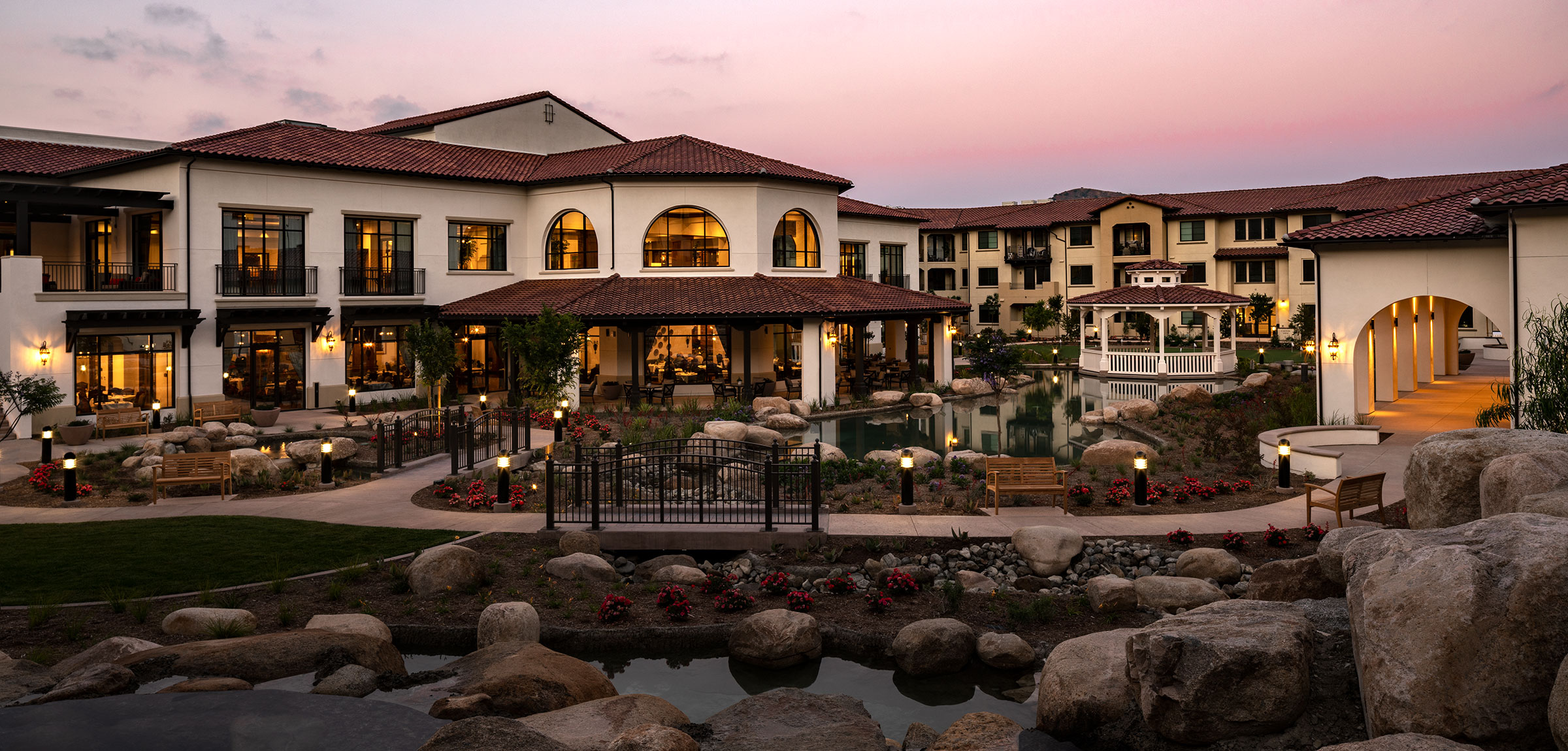 Water features in the foreground and the Reata Glen courtyard at sunset