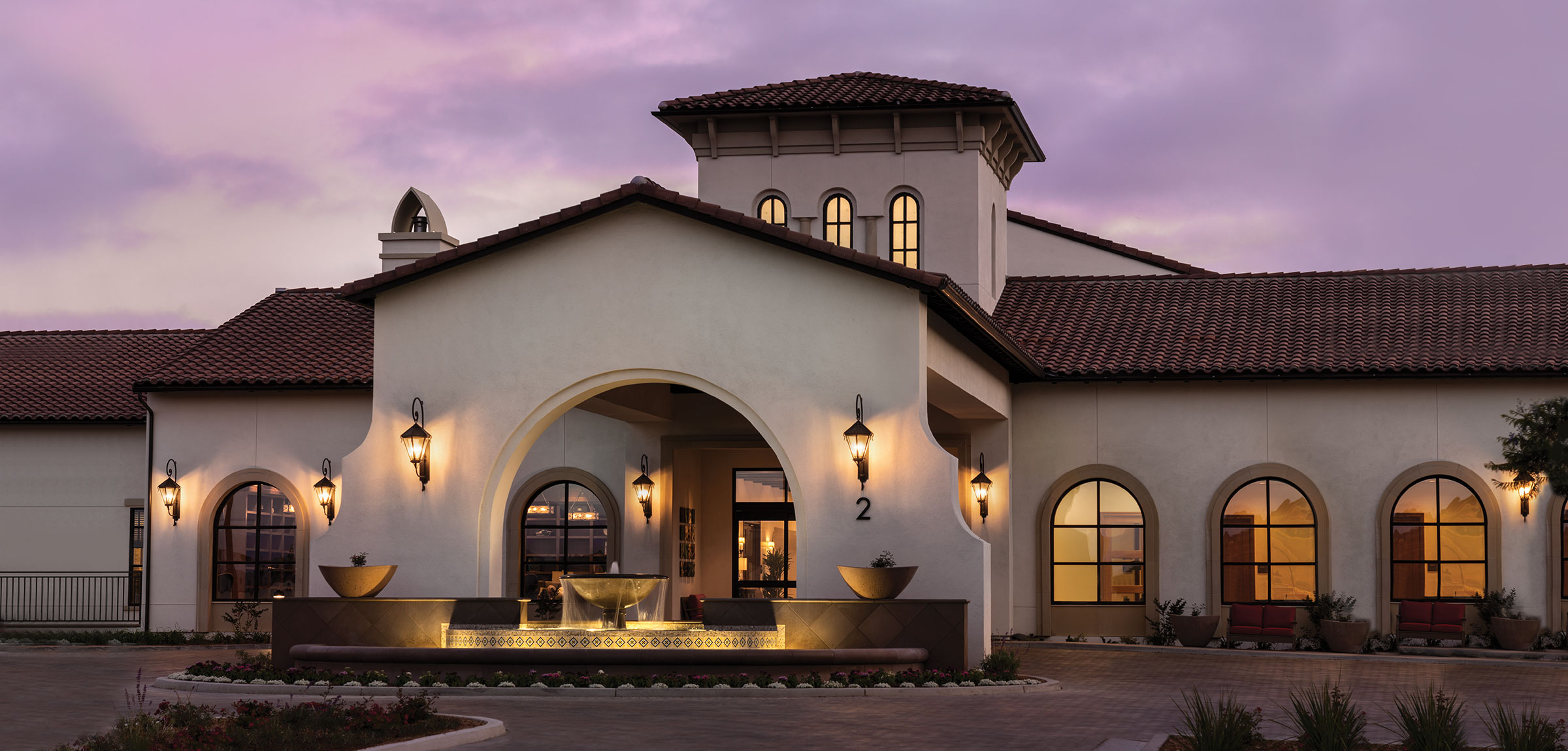 Front view of the Reata Glen entry and driveway at sunset