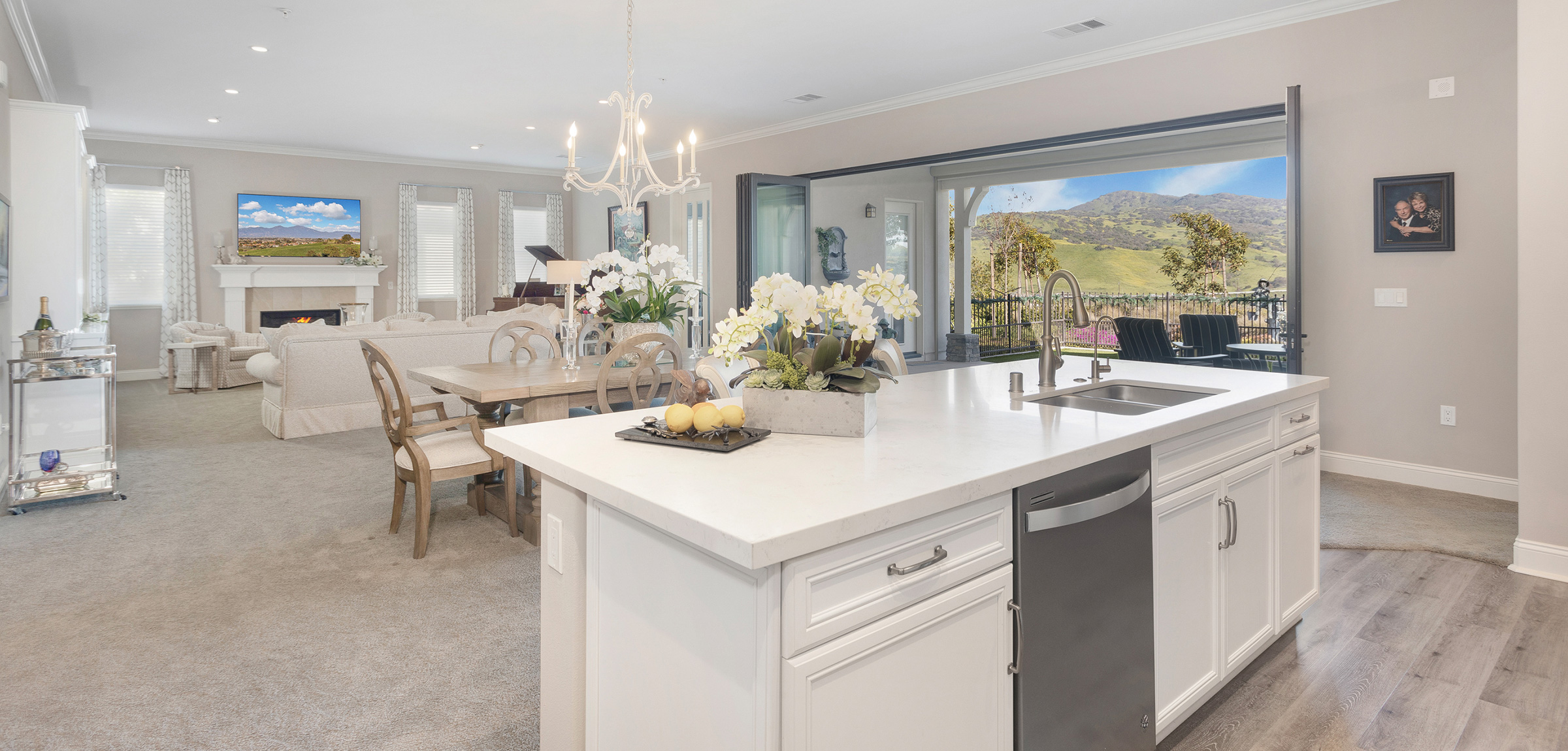 A villa floor plan as seen from the kitchen looking into the living room and open door view of the hills