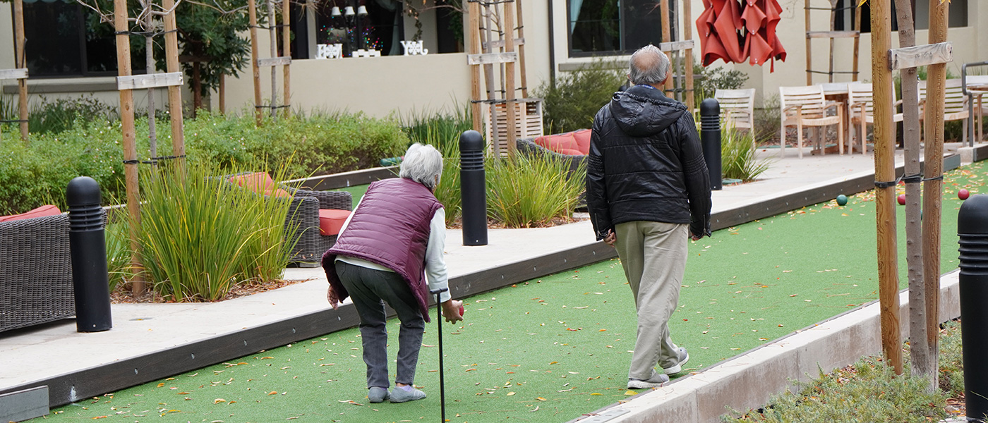 TheGlen-1400x600-23 A couple playing a game of bocce ball together