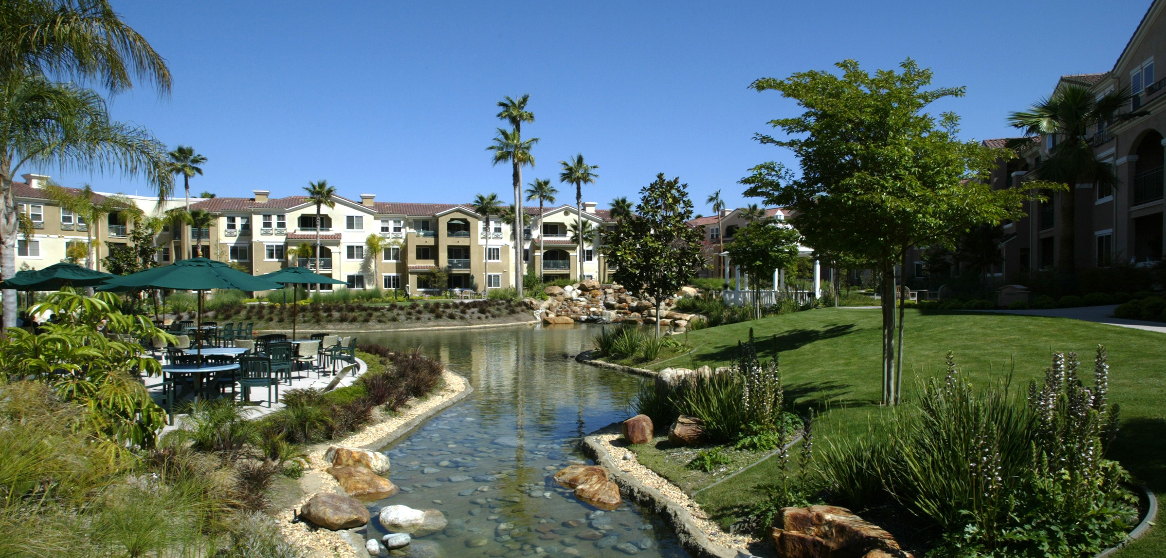 Stream and apartments at La Costa Glen