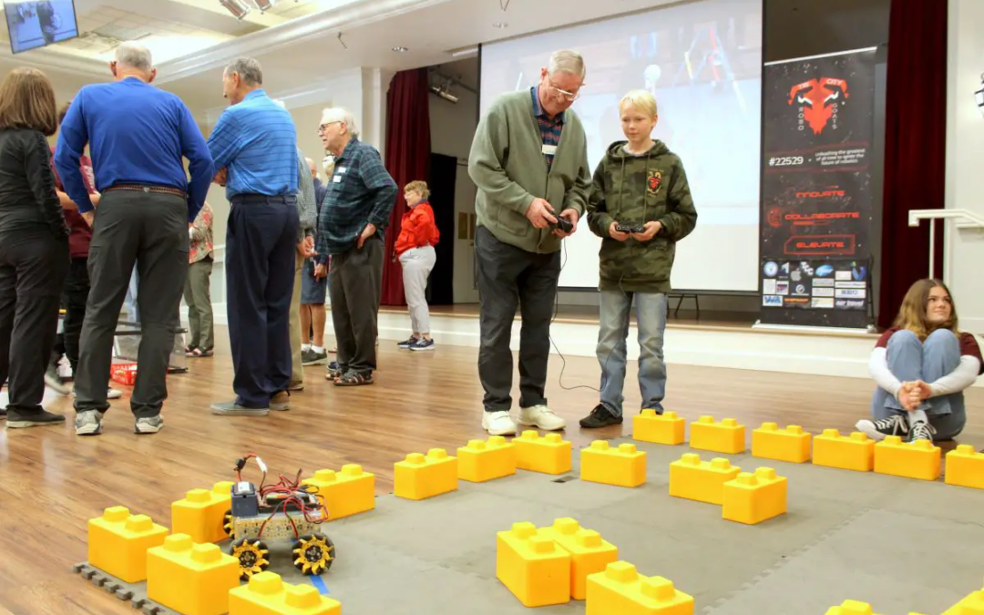 High schoolers showing residents their robotics