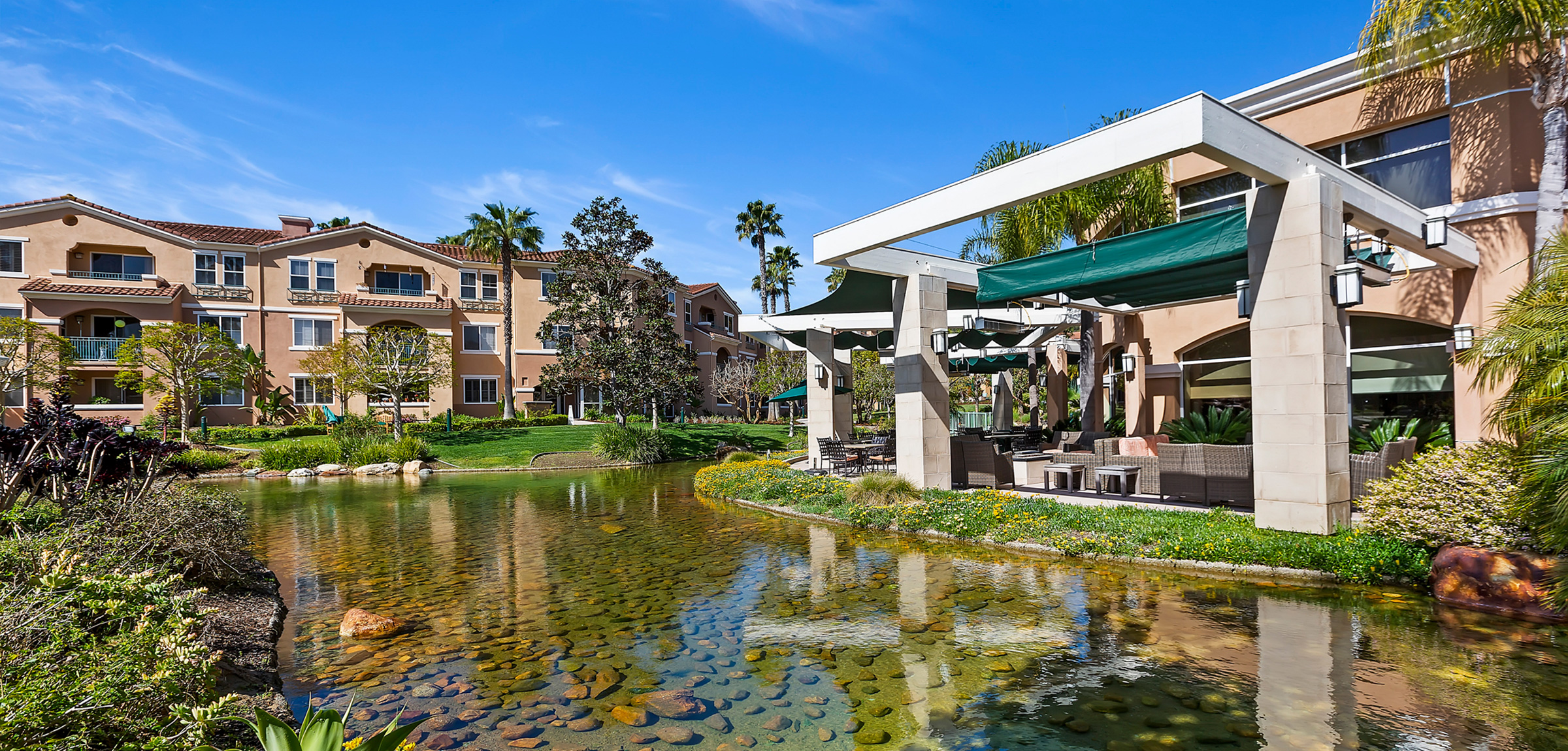 View of stream and apartments at La Costa Glen