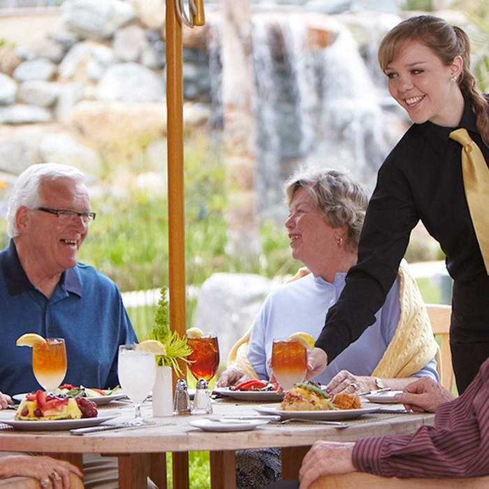 Elderly people being served at a restaurant at La Costa Glen