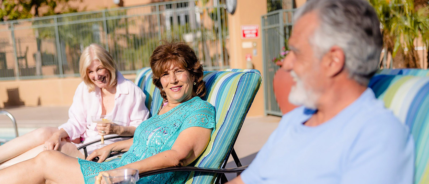 Three elderly residents sitting on lounge chairs at La Costa Glen