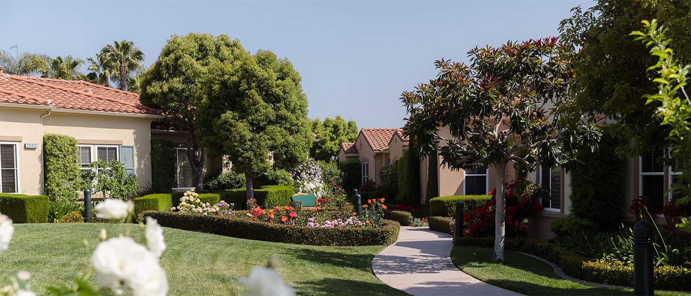 Homes and lawns with flowers at La Costa Glen