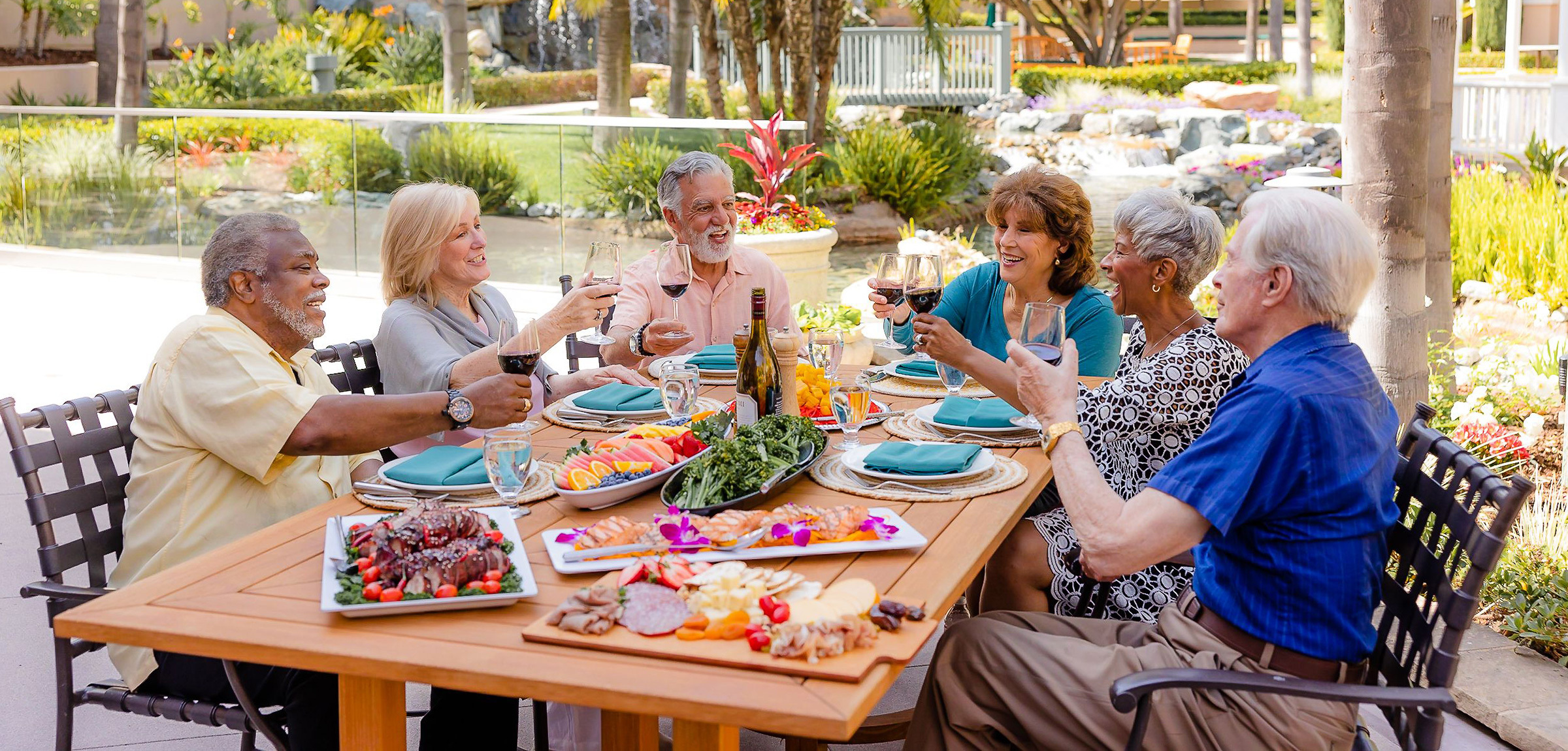A group of residents eating together outdoors