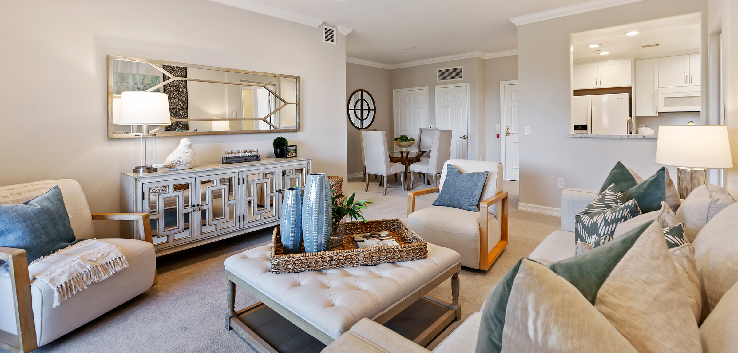 The inside of a residence with couches and tables in the living room