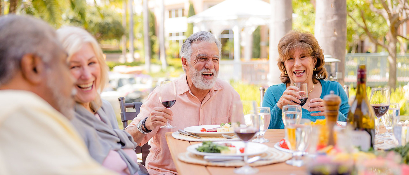 a group of elderly residents eating together