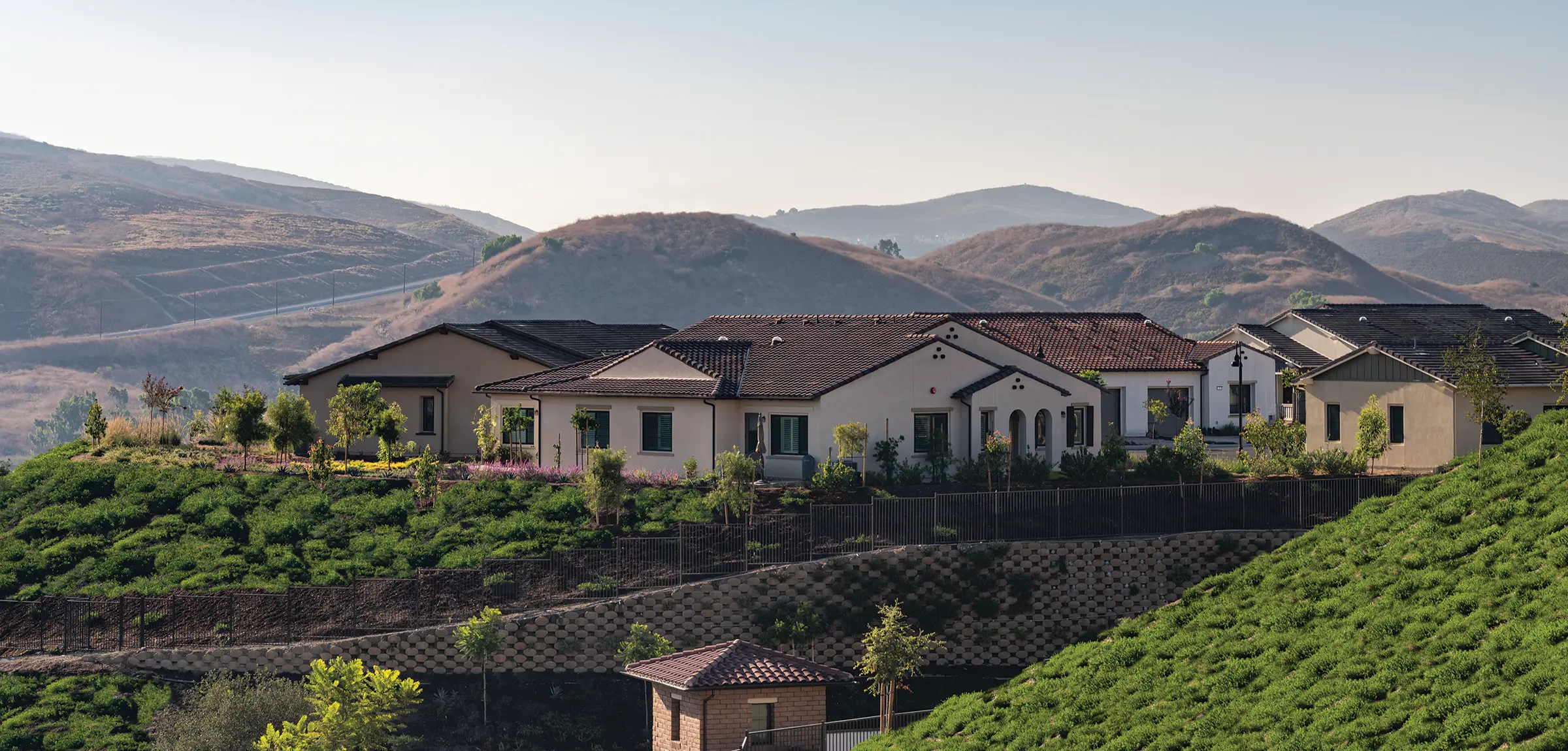 View of a villa, green hills in the foreground